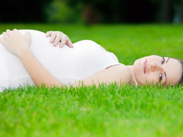 Беременная женщина на траве