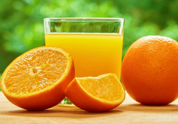Апельсиновый сок в стакане и фрукты